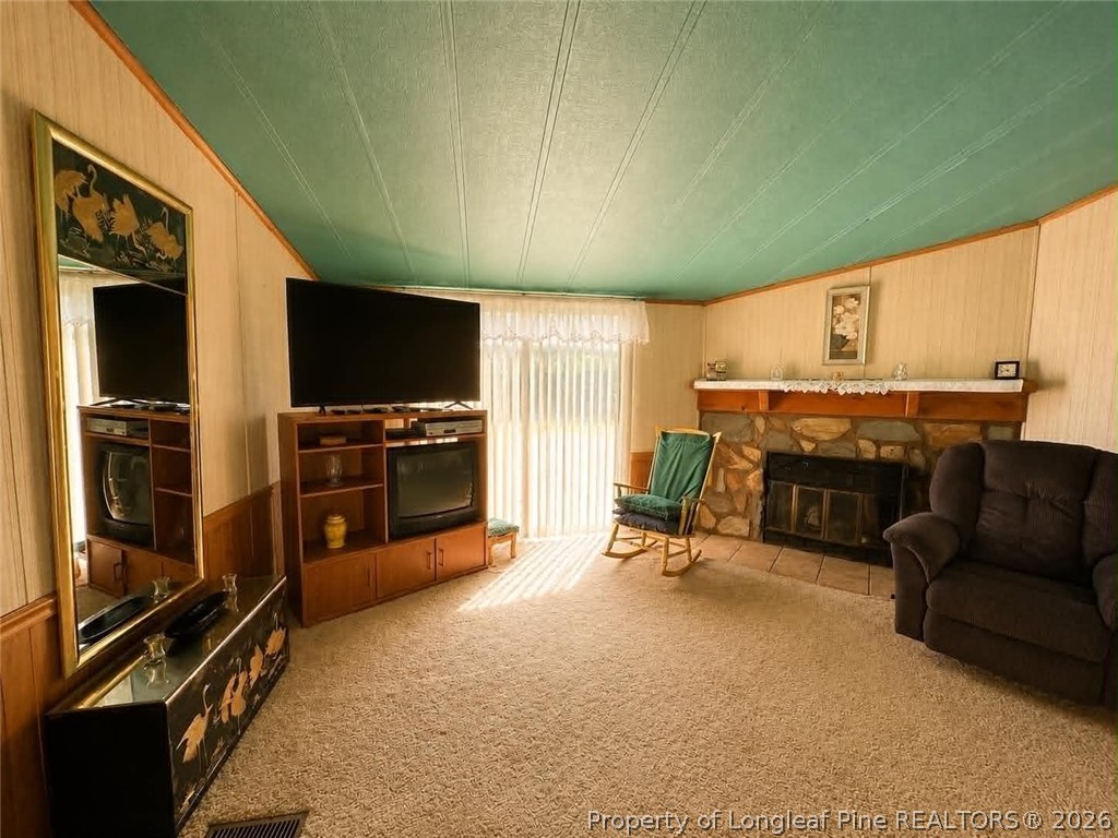 4435 Tartt's Mill Road Wilson, NC 27893 - Photo 3 of 23 a view of a livingroom with furniture and a flat screen tv