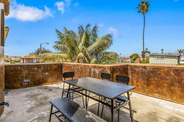 a balcony with a table and chairs