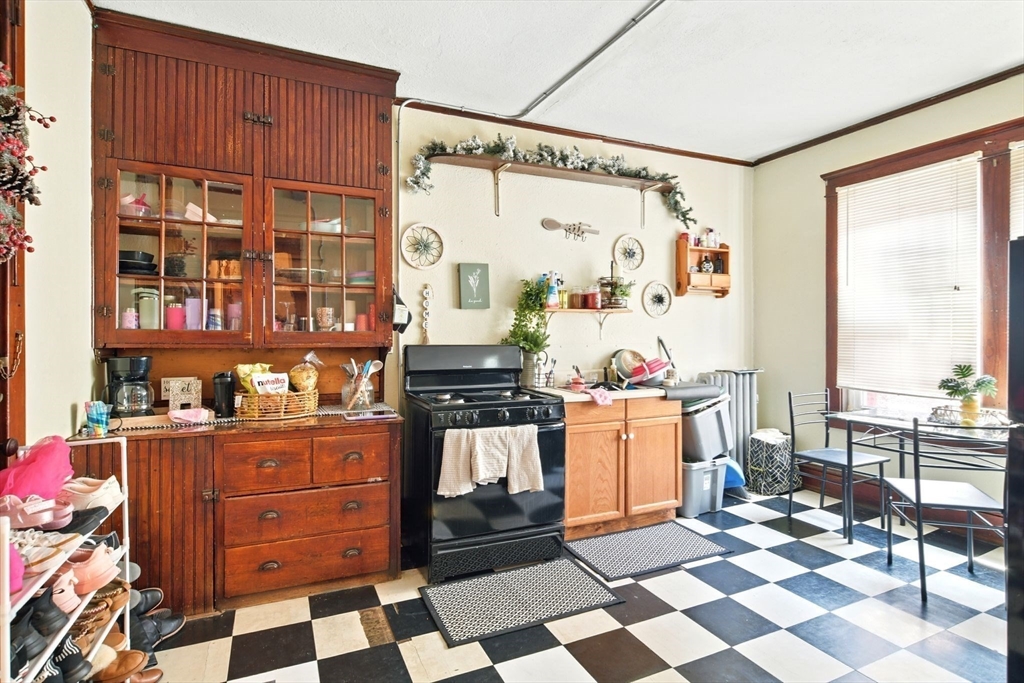 11 Conway Street Greenfield, MA 01301 - Photo 11 of 25 a kitchen with a stove a sink and a refrigerator