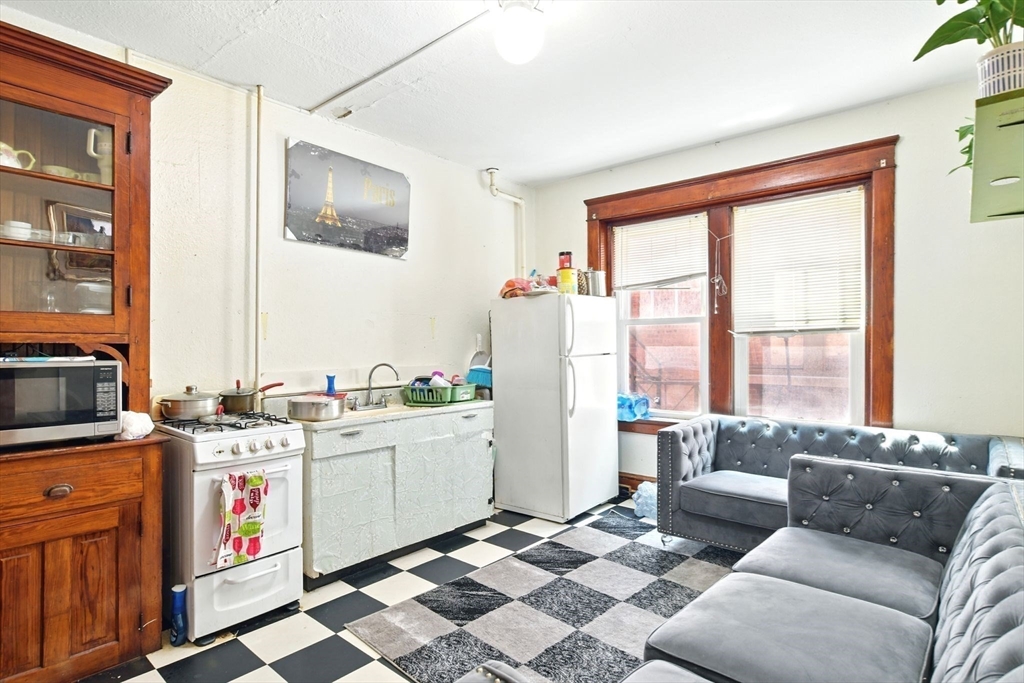 11 Conway Street Greenfield, MA 01301 - Photo 12 of 25 a living room with furniture and large windows