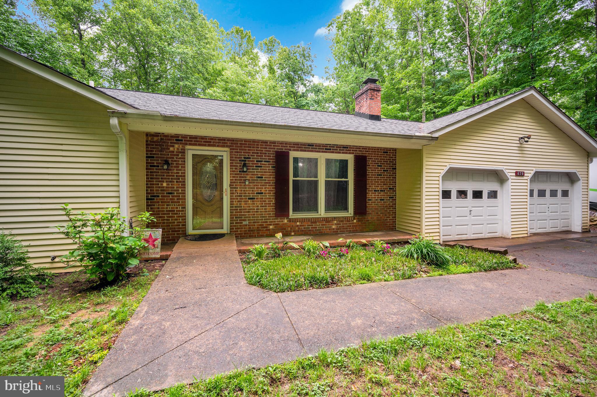679 Cropp Road Fredericksburg, VA 22406 - Photo 5 of 39 a view of a house with a yard and plants