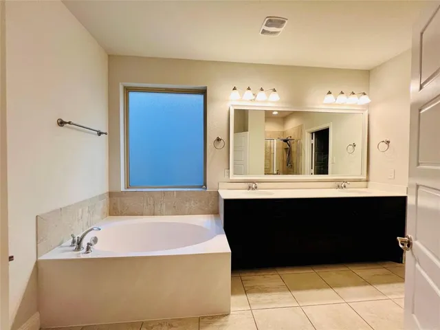 a bathroom with a bathtub and a sink
