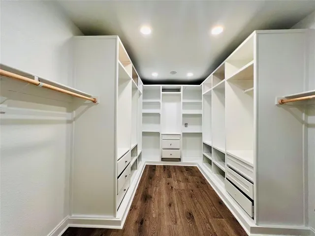 a view of walk in closet with empty racks