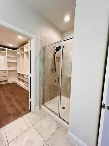 a bathroom with a shower and a glass door