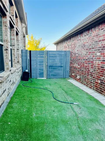 a view of a backyard with wooden fence