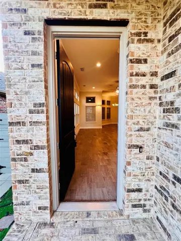 a view of a hallway with wooden floor and a hallway