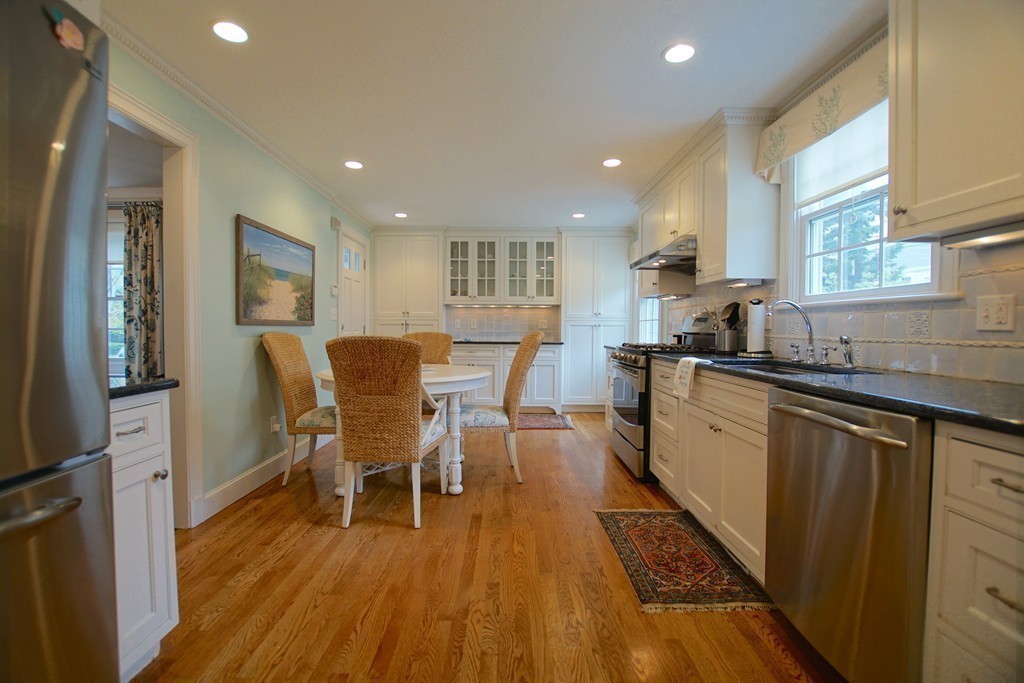 11 Shetland Road Marblehead, MA 01945 - Photo 14 of 28 a kitchen with stainless steel appliances granite countertop wooden floor a dining table chairs and granite counter tops