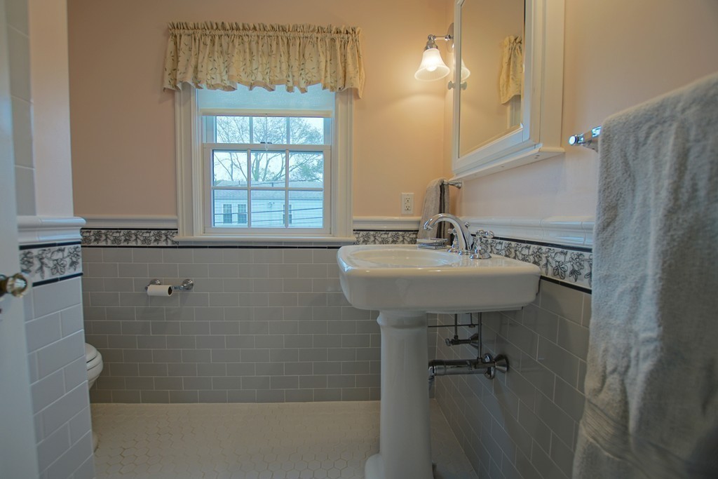 11 Shetland Road Marblehead, MA 01945 - Photo 20 of 28 a bathroom with a sink a mirror and a shower