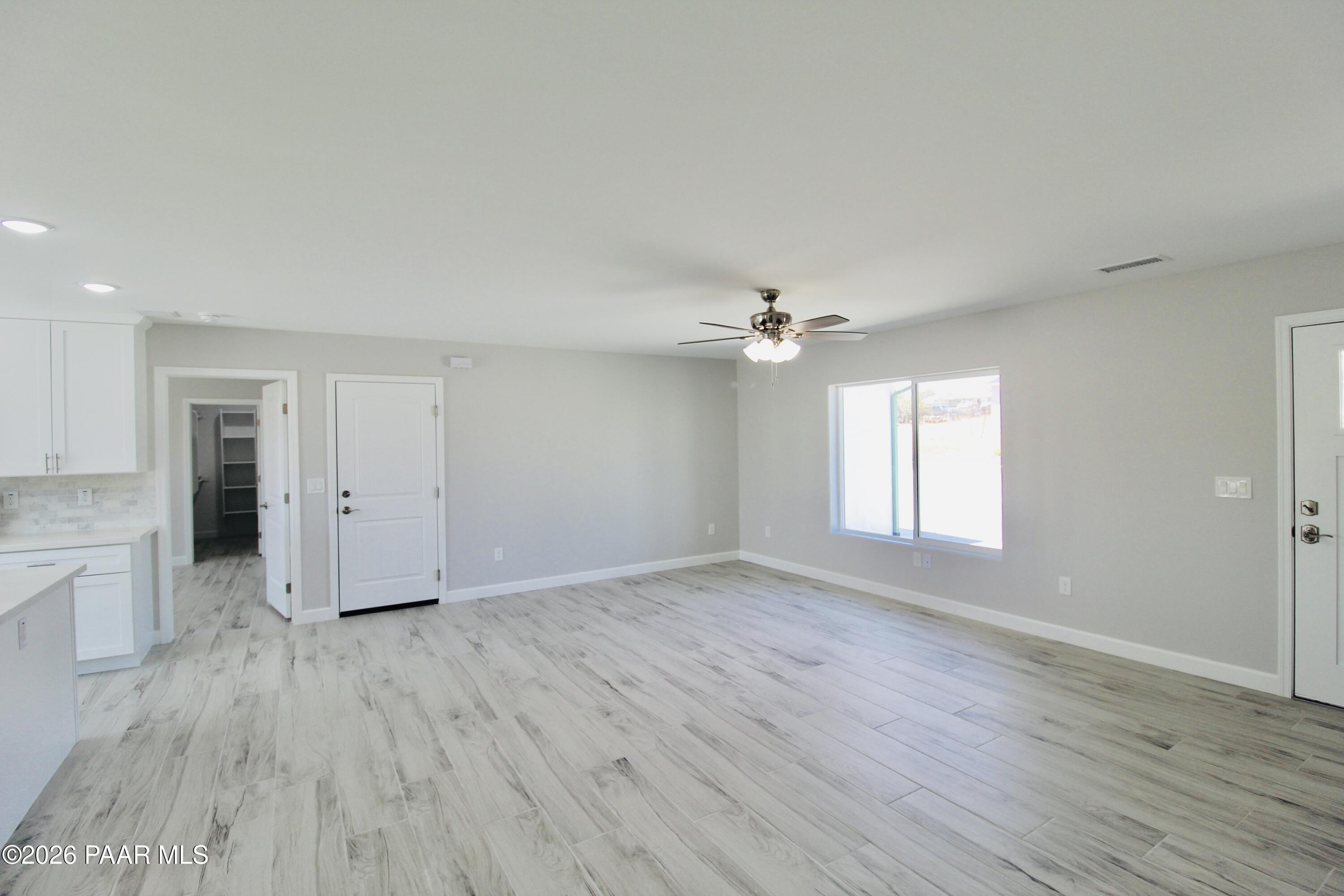 20275 East Mesa Verde Road Mayer, AZ 86333 - Photo 20 of 34 wooden floor in an empty room with a window
