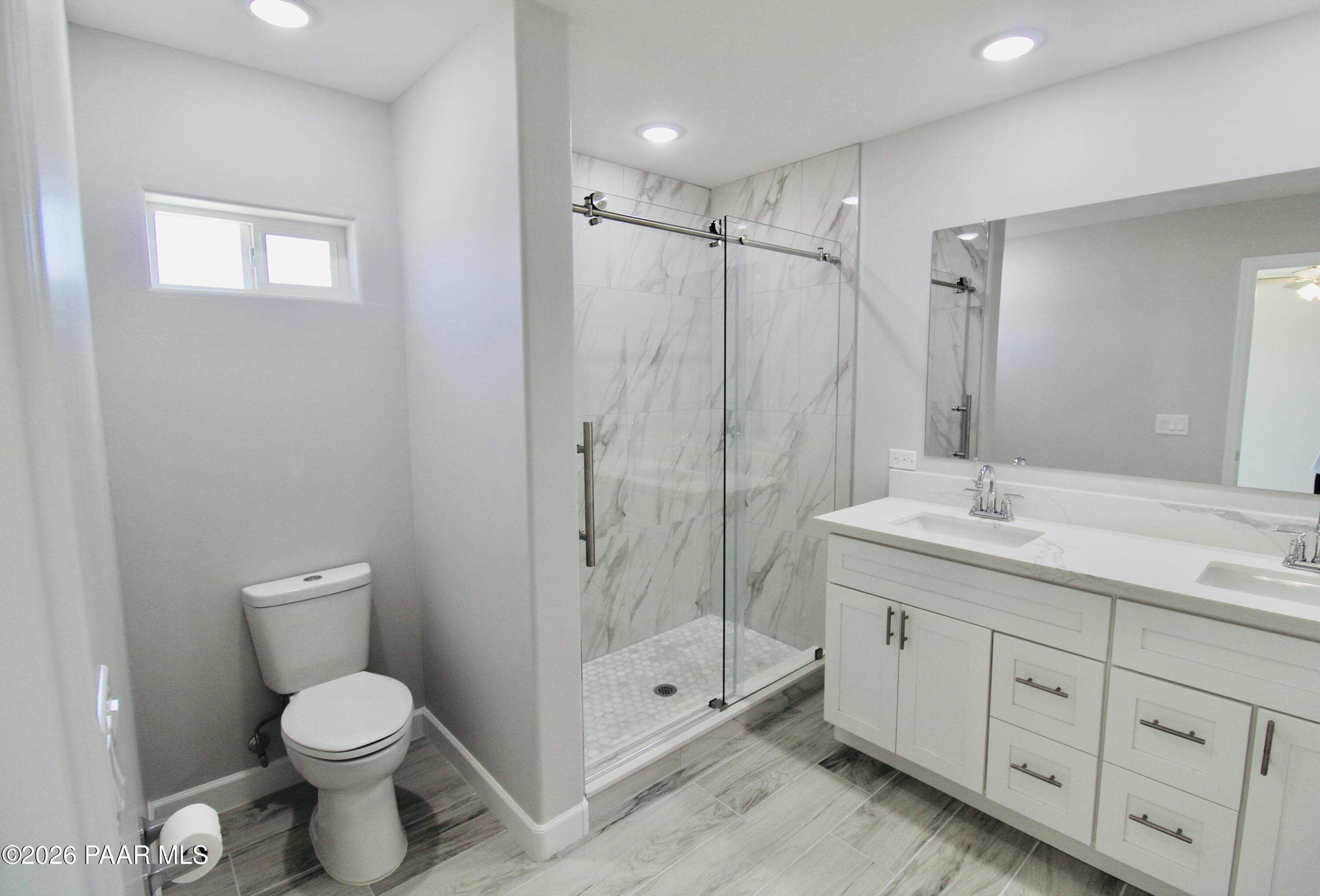 20275 East Mesa Verde Road Mayer, AZ 86333 - Photo 23 of 34 a bathroom with a shower toilet sink and mirror