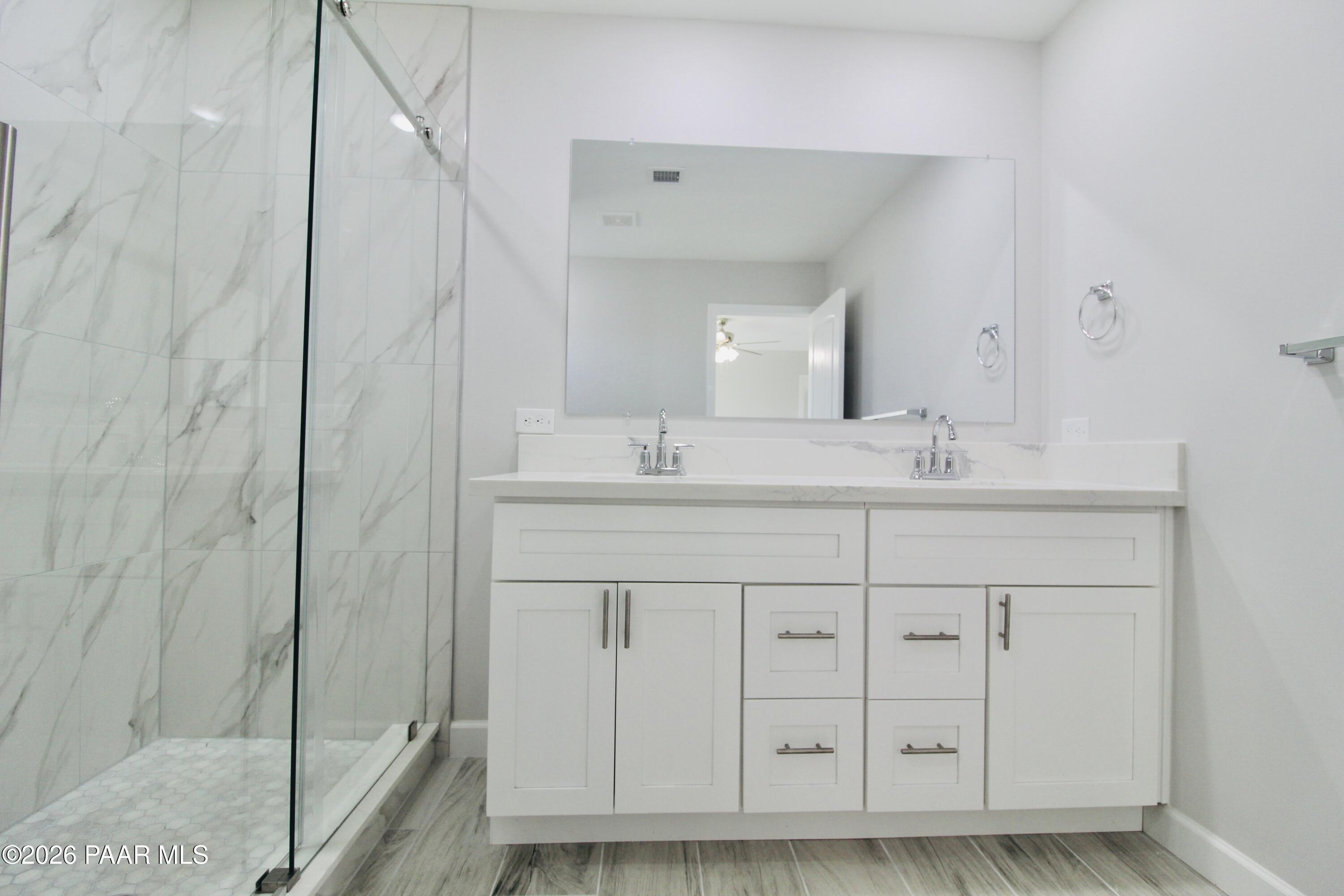 20275 East Mesa Verde Road Mayer, AZ 86333 - Photo 25 of 34 a bathroom with a sink vanity and a mirror