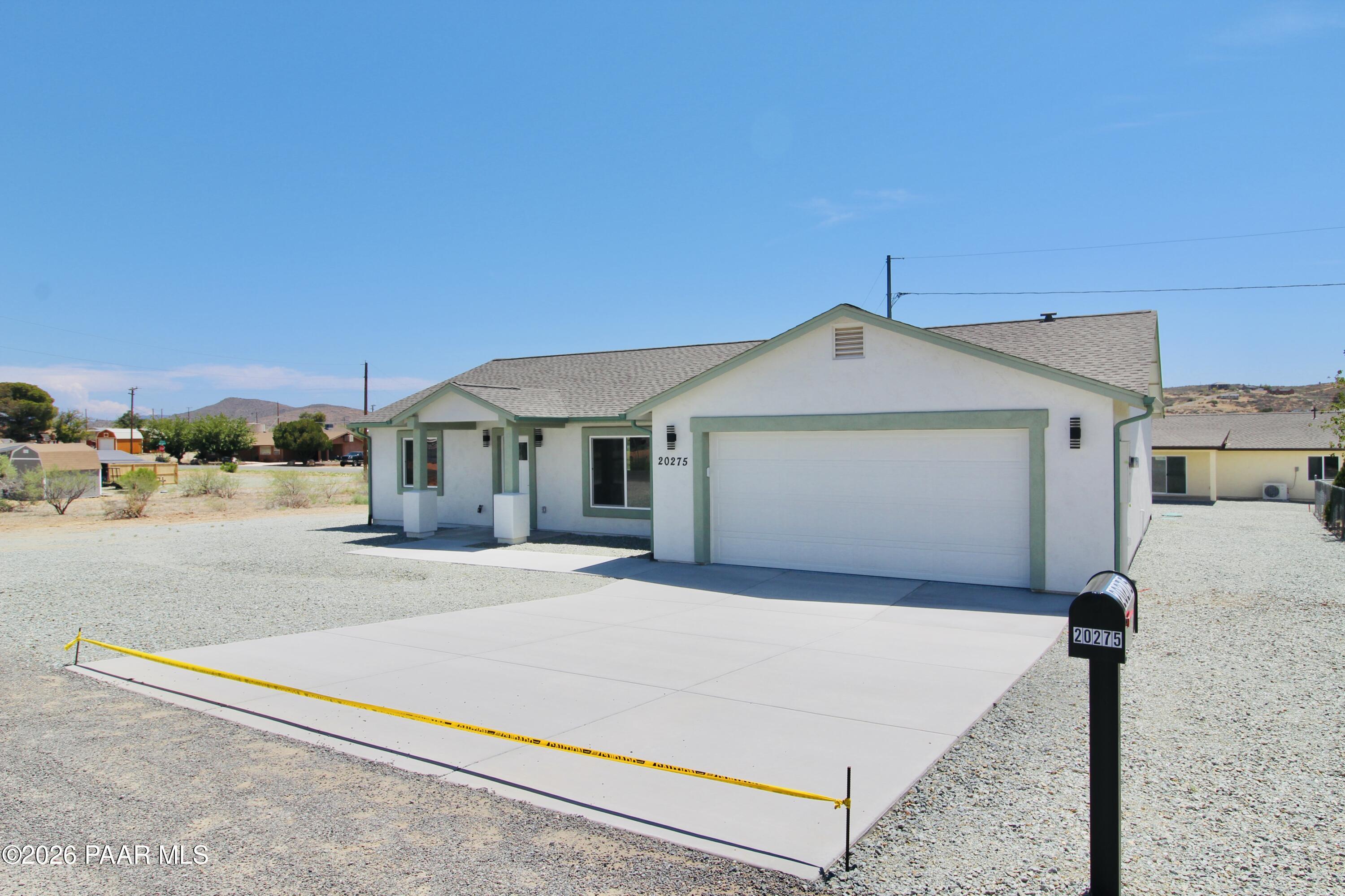 20275 East Mesa Verde Road Mayer, AZ 86333 - Photo 3 of 34 a front view of a house with a yard and garage