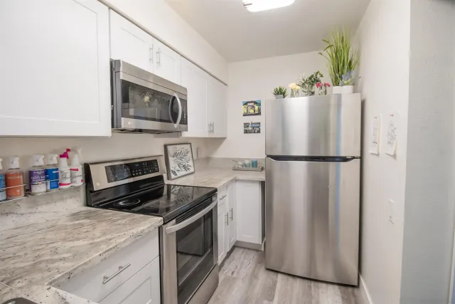 a kitchen with a refrigerator stove and microwave
