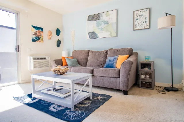 a living room with furniture and painting on the wall