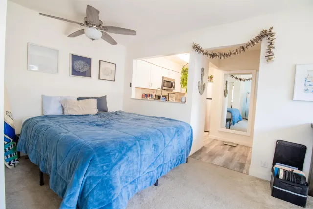 a bedroom with a large bed and a chandelier