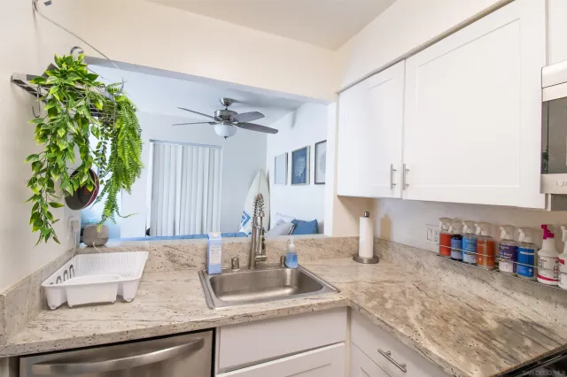 a kitchen with sink and cabinets