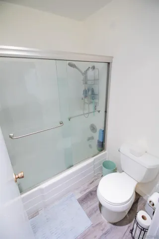 a bathroom with a toilet and a shower