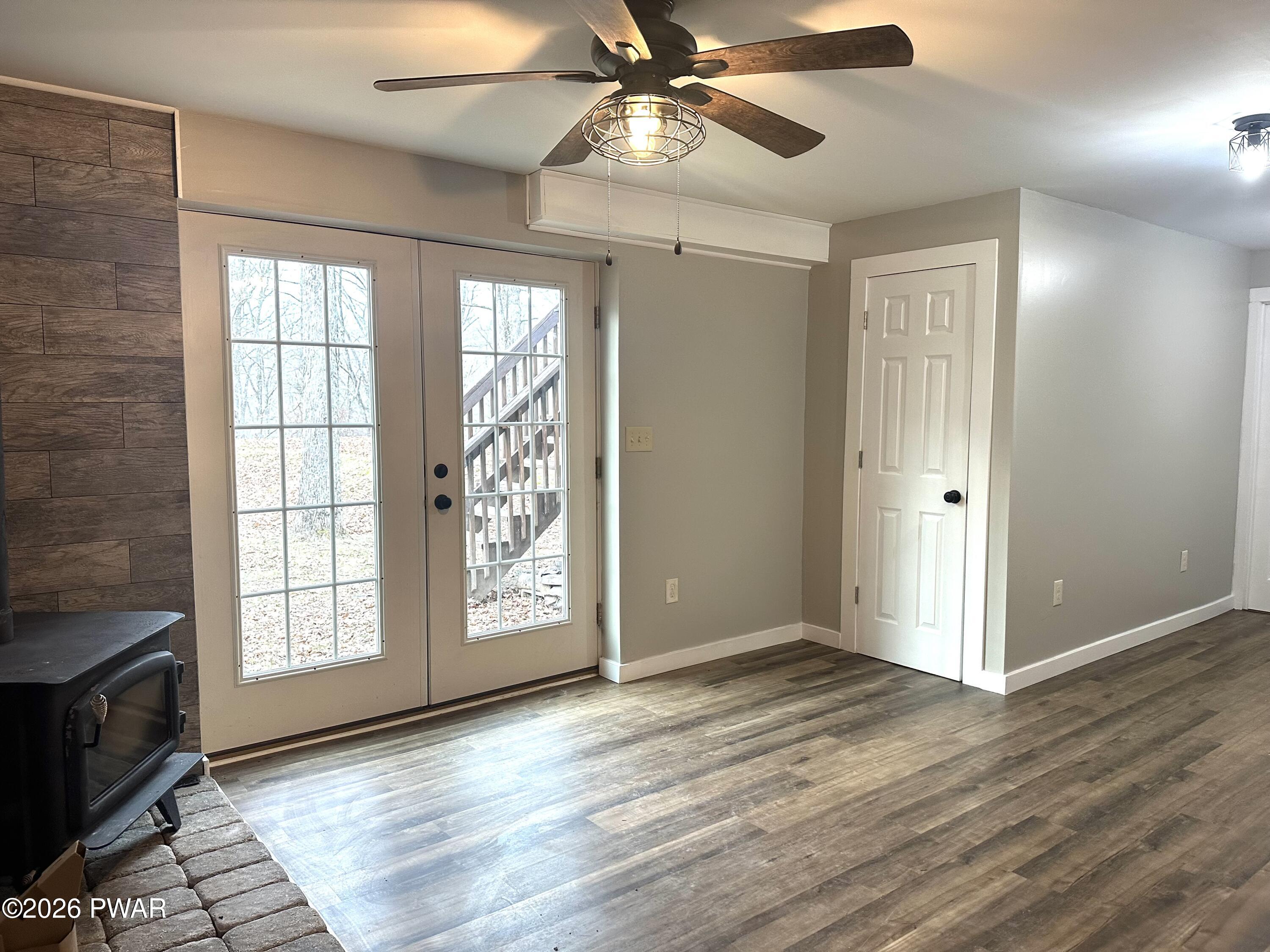 2116 Spring Drive Bushkill, PA 18324 - Photo 14 of 19 an empty room with wooden floor fan and windows