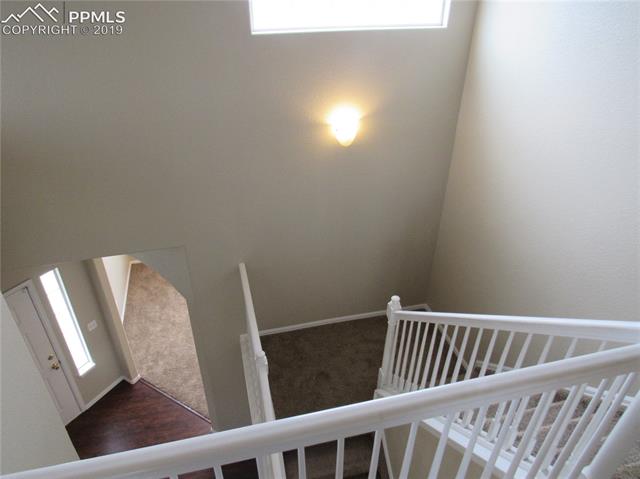 7334 Pearly Health Road Colorado Springs, CO 80908 - Photo 19 of 35 two story stair case