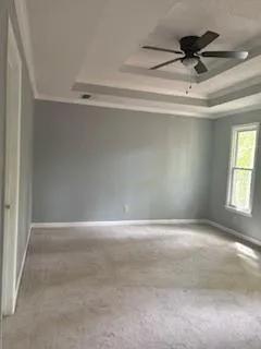 a view of room with a ceiling fan and window