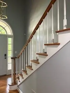 a view of entryway and hall with wooden floor