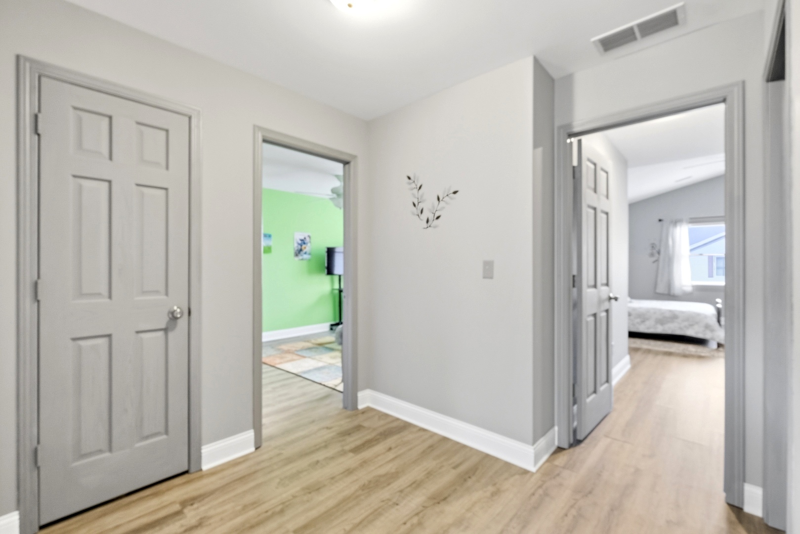1462 Ridge Drive Sycamore, IL 60178 - Photo 21 of 32 a view of a hallway with wooden floor and a bedroom