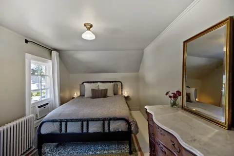 a bedroom with a bed and window