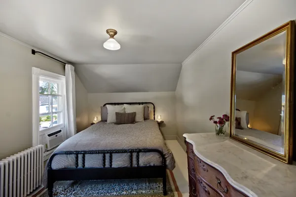 a bedroom with a bed and window