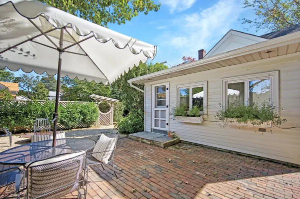 a view of a house with backyard and sitting area