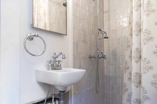a bathroom with a sink a mirror and a shower