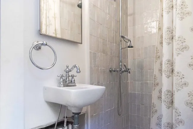 a bathroom with a sink a mirror and a shower