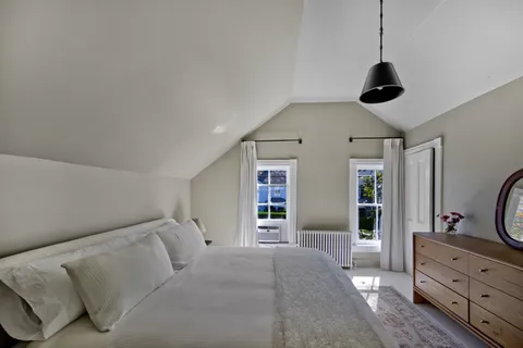 a bedroom with furniture and window