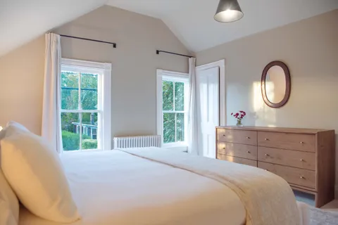 a bedroom with a bed and a window
