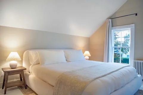 a bedroom with a bed and lamp