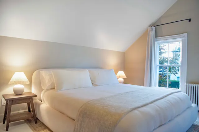 a bedroom with a bed and lamp