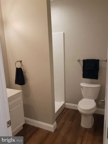 a white toilet sitting next to a sink
