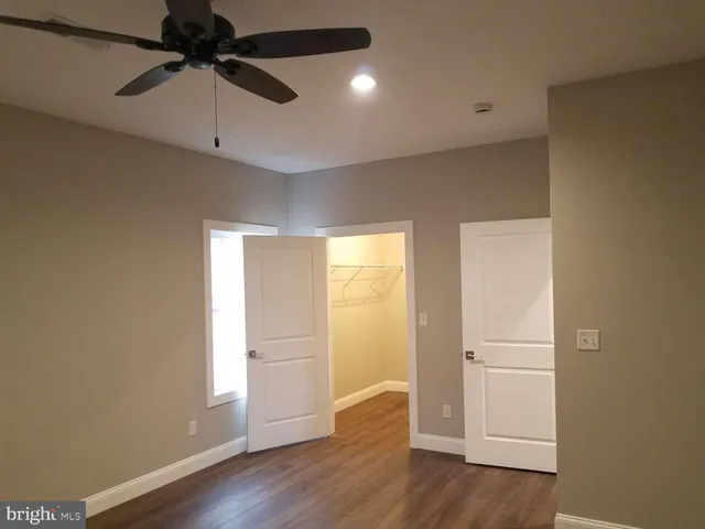 a view of an empty room and wooden floor