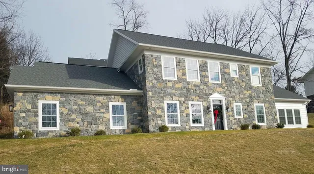 front view of a brick house with a large windows