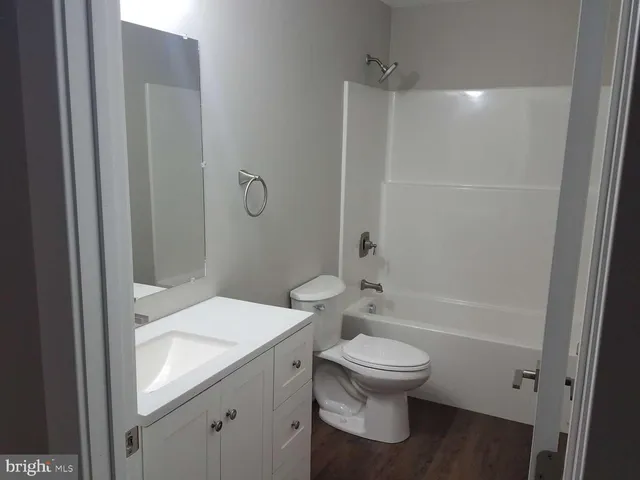 a bathroom with a toilet a sink and shower