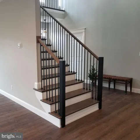 a view of entryway with wooden floor and stairs