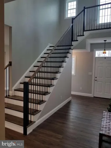 a view of staircase with wooden floor and windows