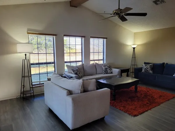 a living room with furniture and a window
