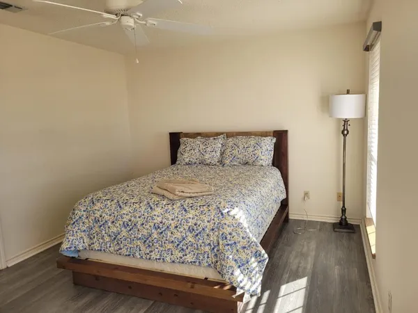 a bed sitting in a bedroom next to a bathroom