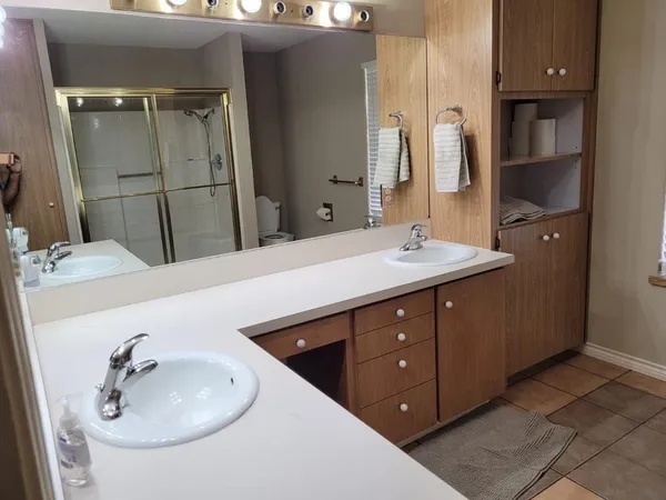a bathroom with a double vanity sink and a mirror
