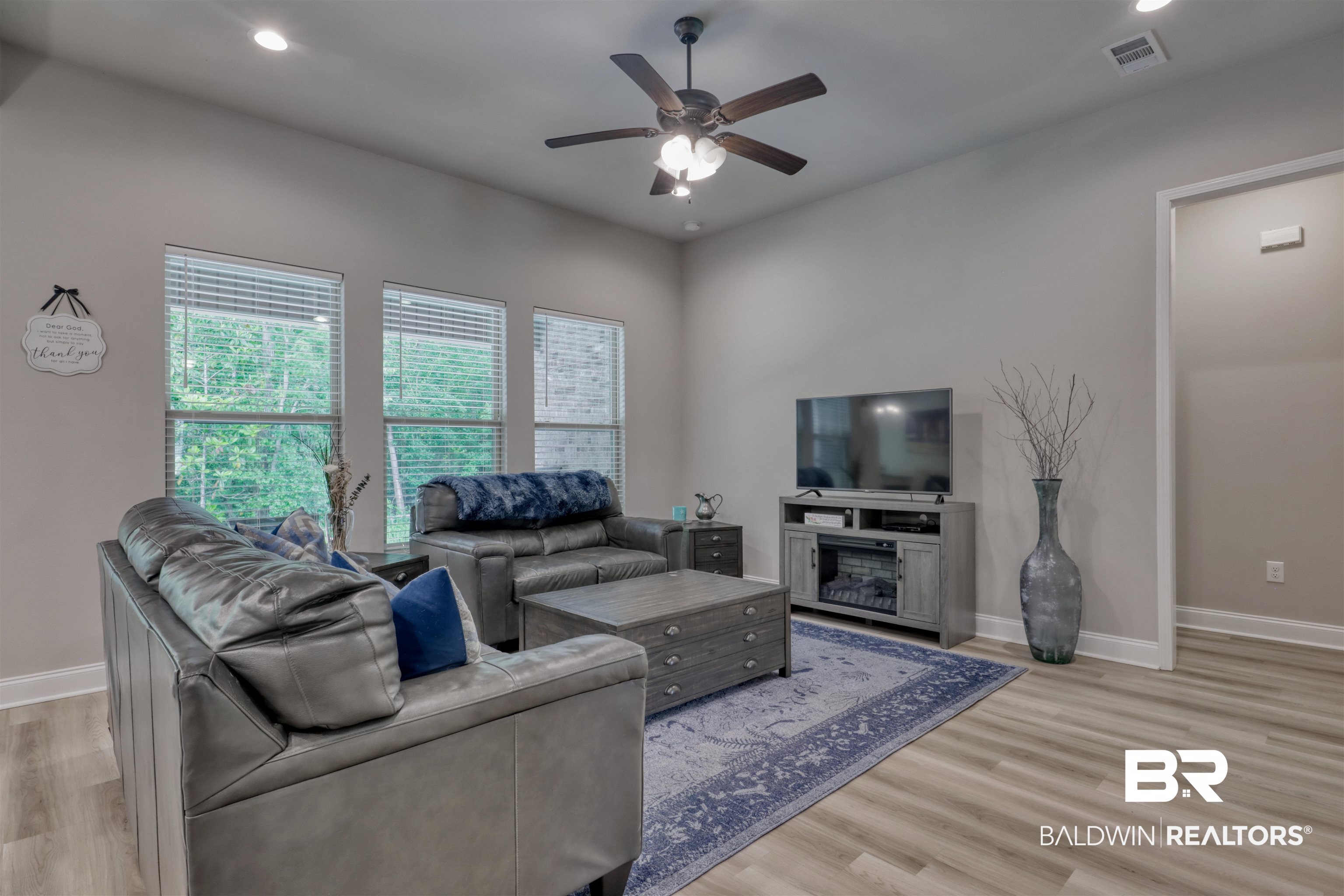 987 Gibson Court Foley, AL 36535 - Photo 8 of 34 Living room with ceiling fan, visible vents, baseboards, and light wood-type flooring