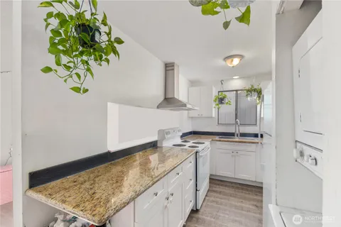 a kitchen with kitchen island granite countertop stainless steel appliances sink stove and cabinets