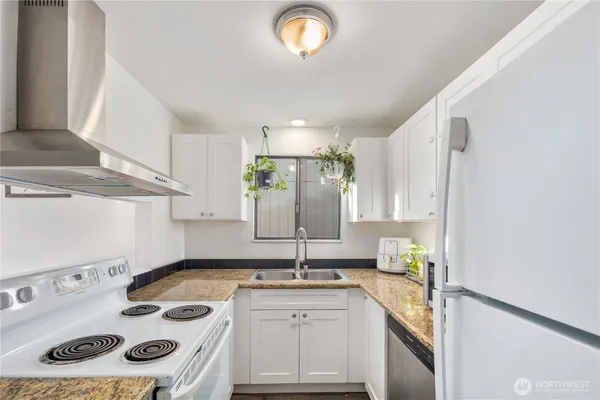 a kitchen with a sink stove and cabinets