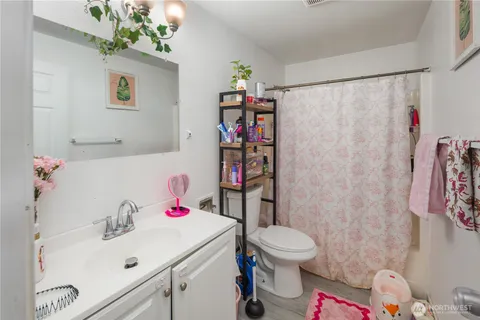 a bathroom with a sink toilet and a shower