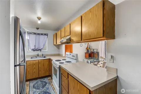a kitchen that has a sink and a stove in it