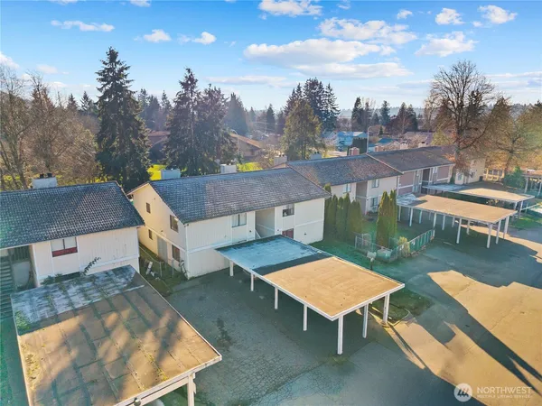 an aerial view of a house with swimming pool and a yard